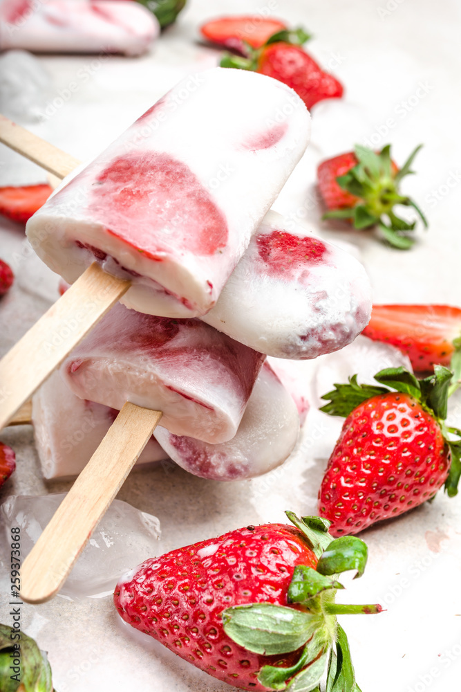 Homemade popsicles with yogurt or ice cream with strawberries Homemade popsicles with yogurt or ice cream with strawberries