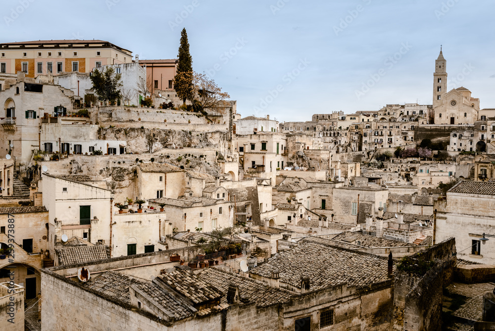 Panoramic view of the city of Matera in Italy, ancient curious village for tourists to be built inside the rocks in caves and stone houses, seen from the top.
