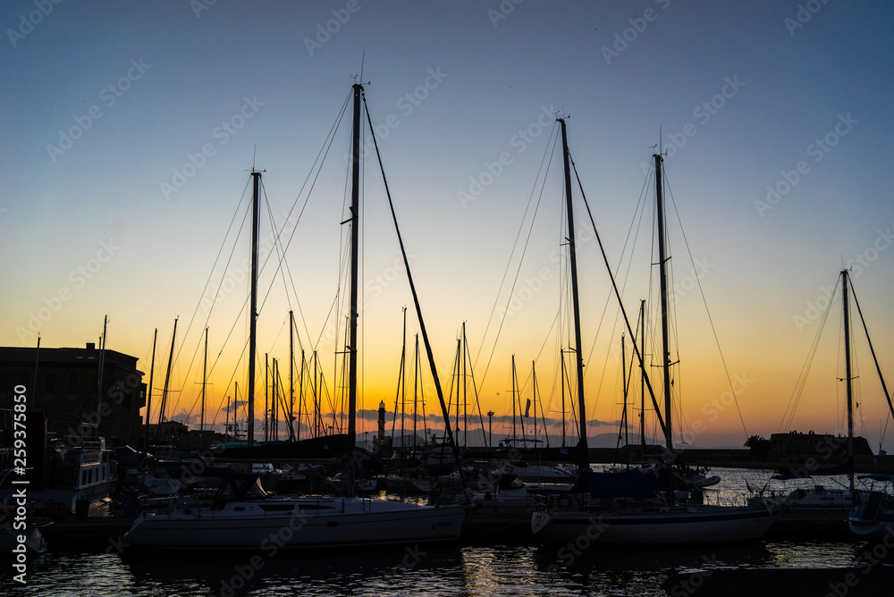 The evening sun and yacht mast silhouette