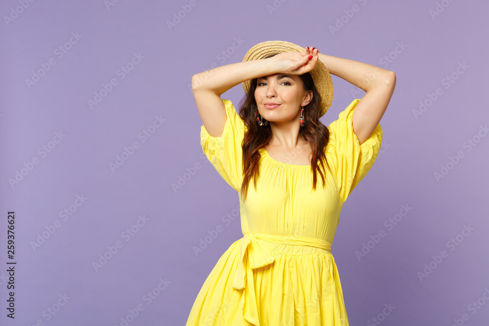 Attractive young woman in yellow dress summer hat looking camera, putting hands on head isolated on pastel violet background in studio. People sincere emotions, lifestyle concept. Mock up copy space. Attractive young woman in yellow dress summer hat looking camera, putting hands on head isolated on pastel violet background in studio. People sincere emotions, lifestyle concept. Mock up copy space.