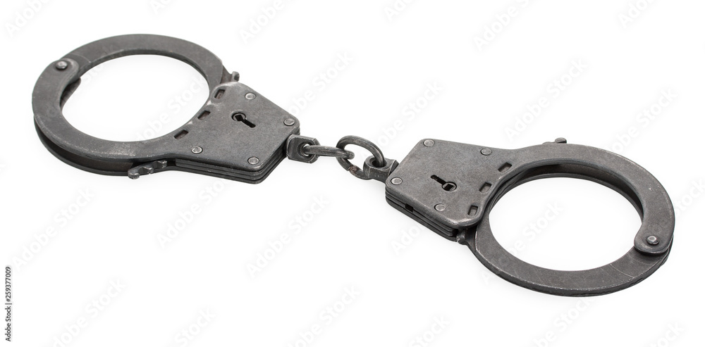 Pair of closed lock steel metal handcuffs isolated on white background. Pair of closed lock steel metal handcuffs isolated on white background.