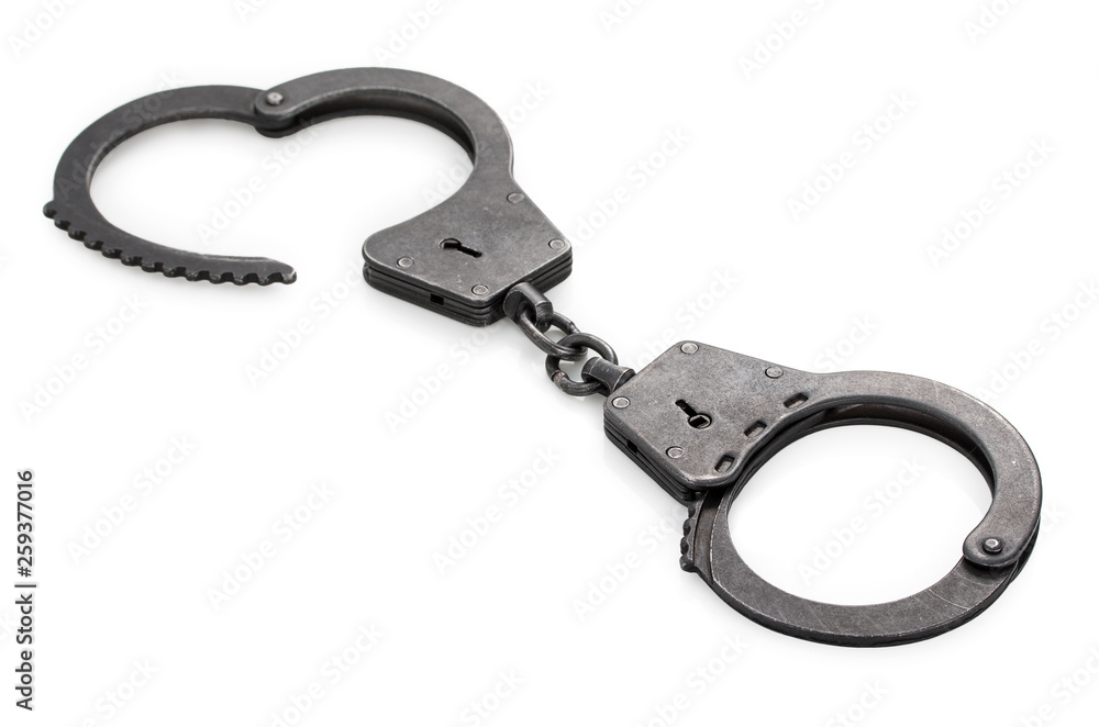 Pair of closed lock steel metal handcuffs isolated on white background. Pair of closed lock steel metal handcuffs isolated on white background.
