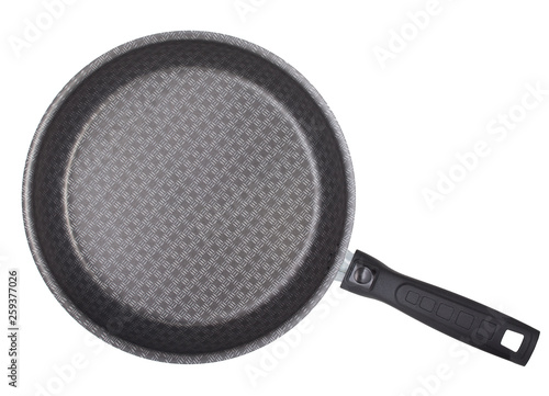 Black frying pan with nonstick surface isolated on white background, close-up, top view.