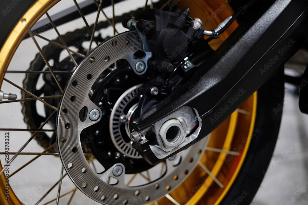 Disc brake with wheel hub on a motorcycle. Close up rear disc brake on a motorcycle. Car care and maintenance concepts. - Selective focus