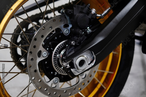 Disc brake with wheel hub on a motorcycle. Close up rear disc brake on a motorcycle. Car care and maintenance concepts. - Selective focus