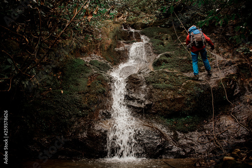 Young man dulfers down the mountain with waterfall in Adjara © fesenko