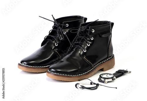Men’s black boots and watch isolated on a white background.