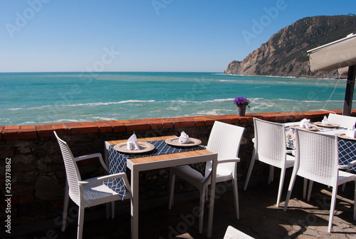 Table set on a panoramic terrace of a restaurant in Monterosso village