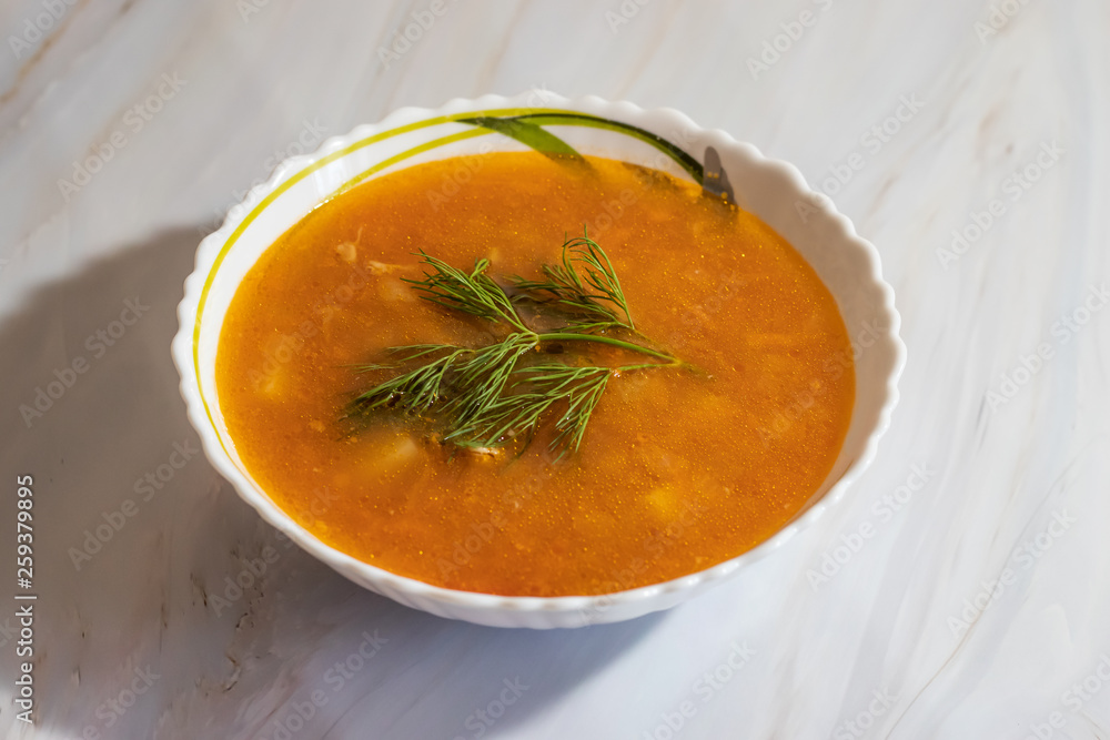 Veggie pea soup with carrots and dill on a white background Veggie pea soup with carrots and dill on a white background