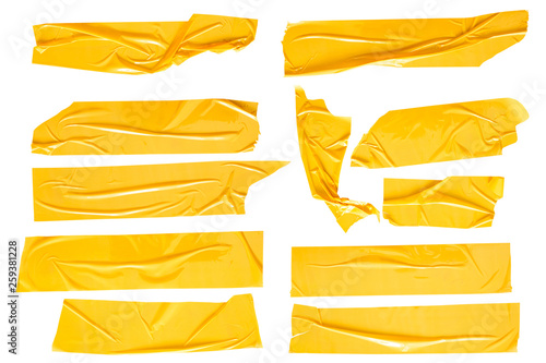 Set of yellow tapes on white background. Torn horizontal and different size yellow sticky tape, adhesive pieces. photo