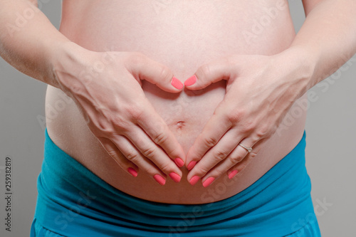 Wallpaper Mural Young Pregnant Woman with Hands Forming Heart Shape. Torontodigital.ca