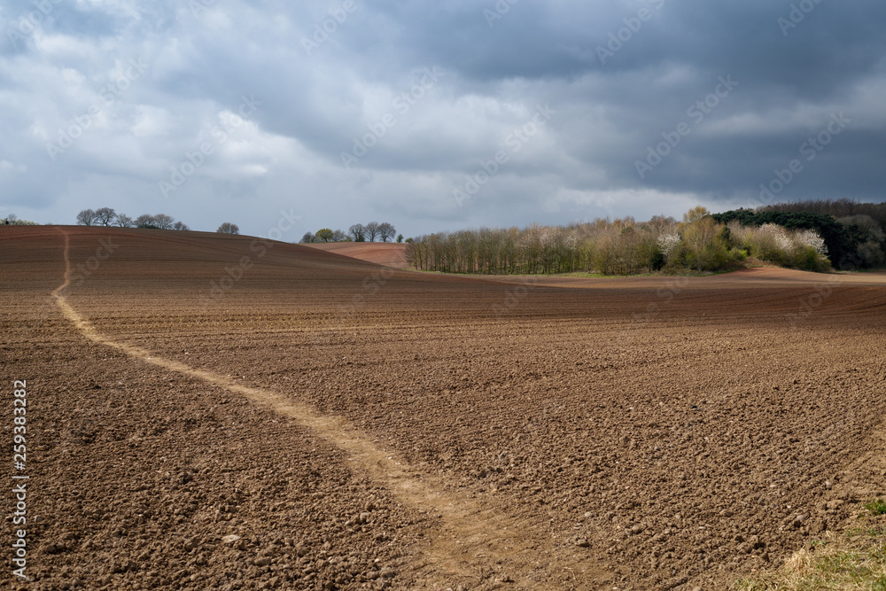 Nottinghamshire Landscape on a dramatic Springtime afternoon views and footpath across plowed fields 
