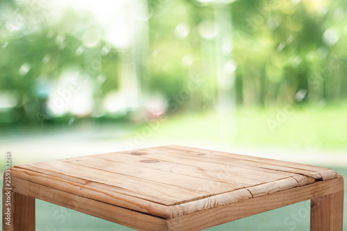 empty wooden on blurred nature backdrop. Wood table top. can used for display or montage your products © ooddysmile