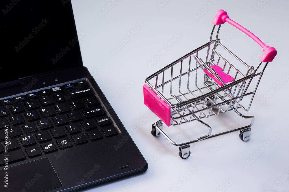Shopping service on The online web. offers home delivery. Empty shopping cart on a laptop keyboard