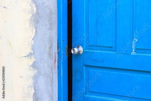 Steel door handle in a blue wooden door (Ari Atoll, Maldives)