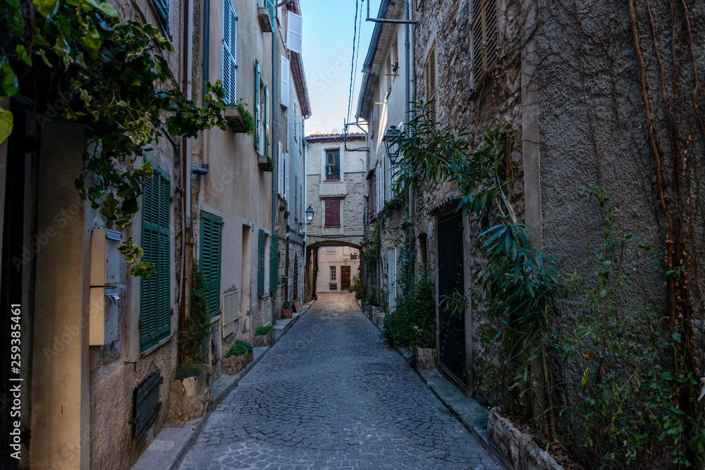 Little alley in the medieval village of Antibes in a sunny winter day