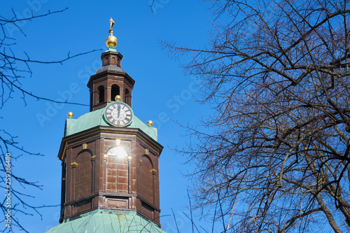 Reflection of sun on a clocktower of a church in Stockholm, Sweden.