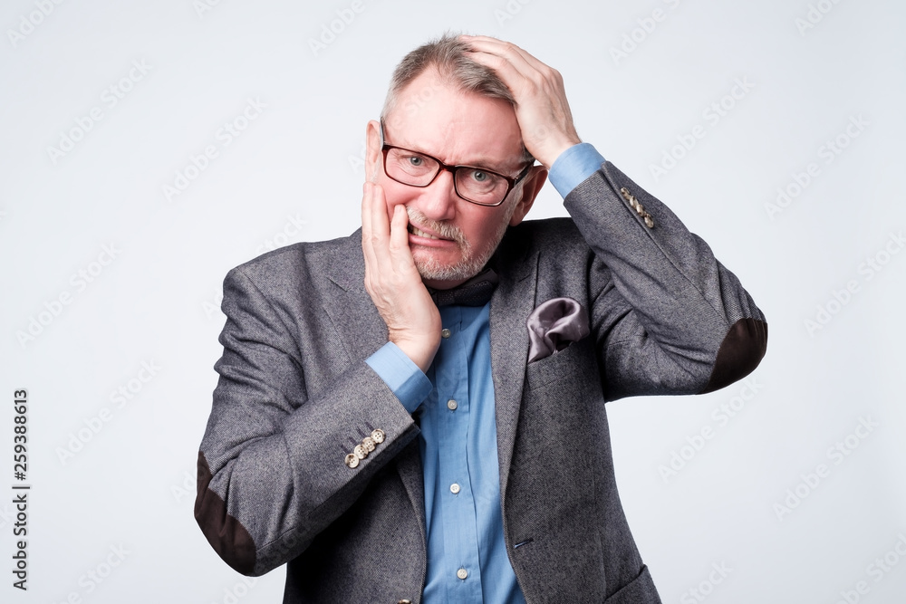 man holding hand on his head having forgetful look man holding hand on his head having forgetful look