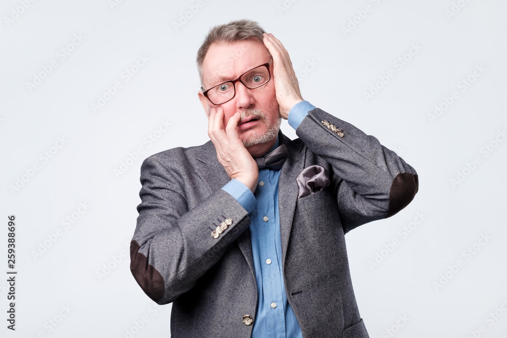 man holding hand on his head having forgetful look man holding hand on his head having forgetful look