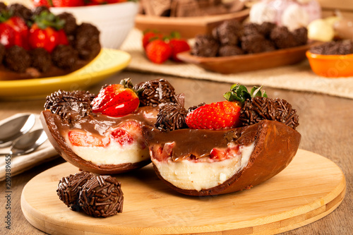 Obraz na płótnie Gourmet easter egg, stuffed with chocolate and strawberry. Easter egg with pudding cream, Easter dessert. Easter concept. w salonie