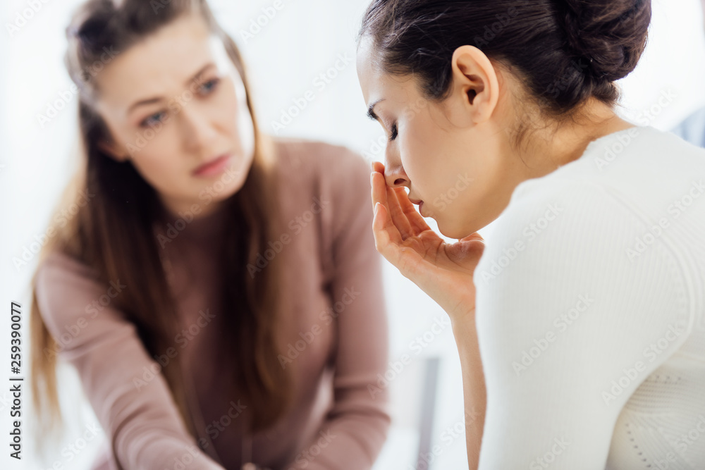 selective focus of woman crying during therapy session selective focus of woman crying during therapy session