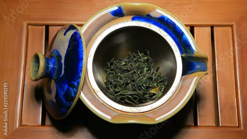 Green Tea Maofeng teapot bamboo desk hd footage  photo