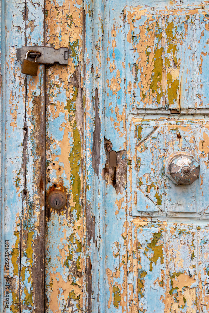Detail of a beautiful old, light blue painted, weathered, locked door at Rabat Malta Detail of a beautiful old, light blue painted, weathered, locked door at Rabat Malta