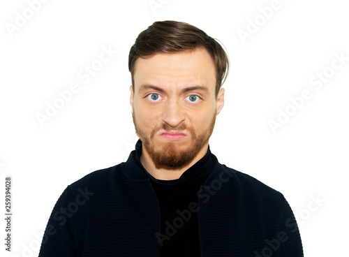 portrait of angry young man, isolated on white wall background.