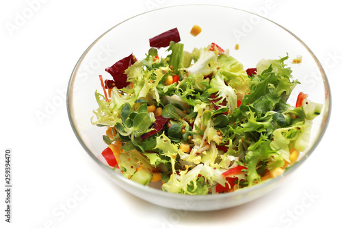 fresh salad in a glass bowl. Salad. Organic food. Healthy vegetable salad with escarole endive, frisee endive, chicory radicchio, lettuce in a glass bowl. Vegetarian food.