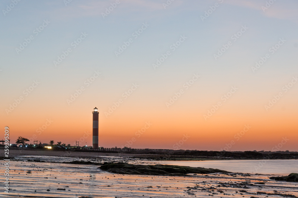 Dusk shot at Shivrajpur beach gujarat India with lighthouse and waves