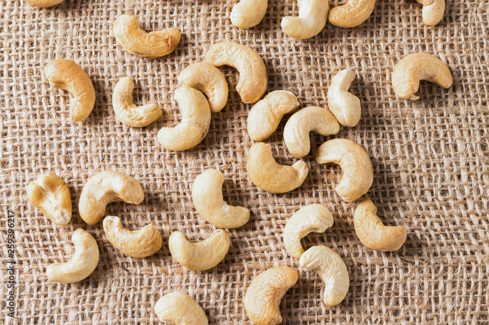 A lot of nuts - cashew nuts on the grey background, top view
