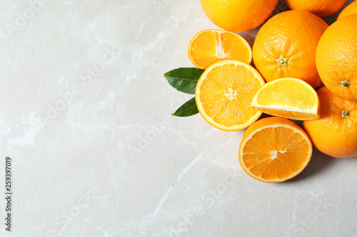 Flat lay composition with ripe oranges and space for text on light background