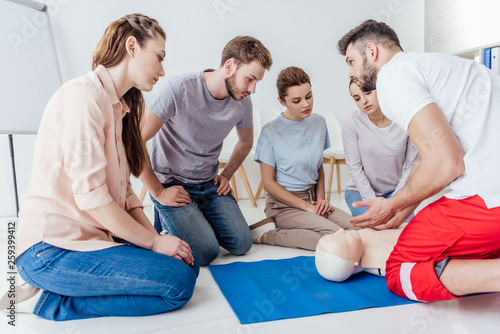 instructor gesturing during first aid training with group of people