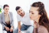 selective focus of worried woman during group therapy session