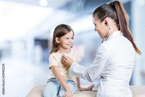 Young woman doctor with little girl  in a hospital photo
