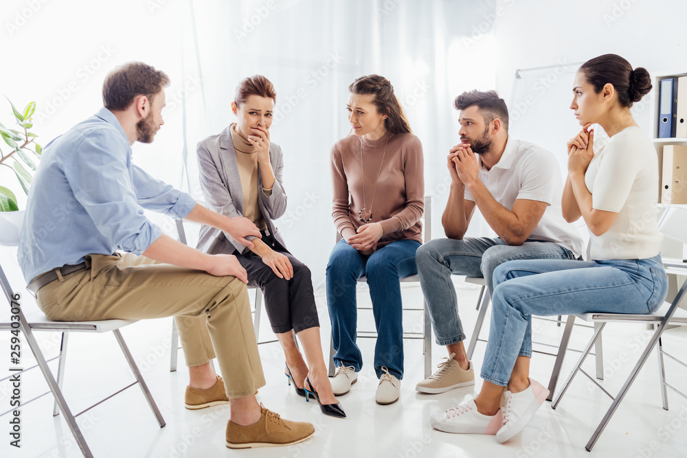 people sitting on chairs and having group therapy meeting people sitting on chairs and having group therapy meeting