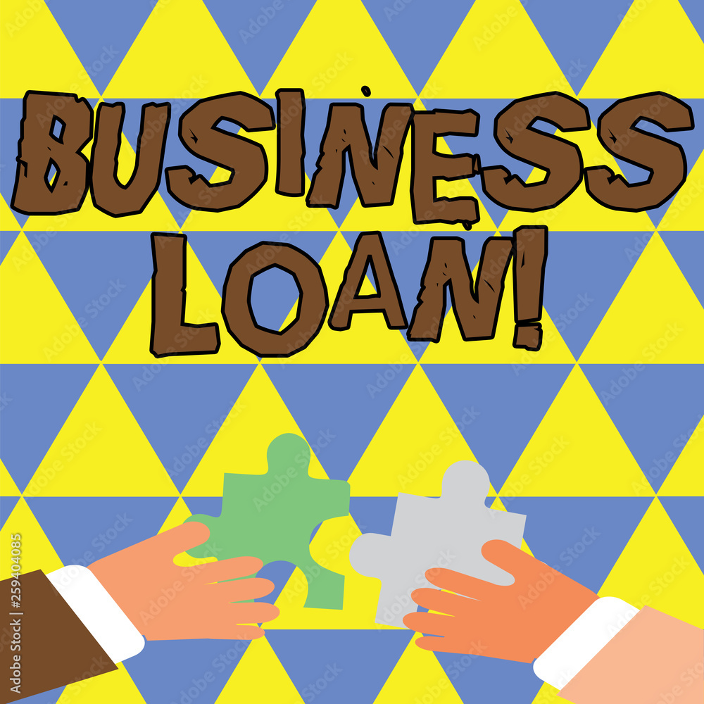 Writing note showing Business Loan. Business concept for creation of debt which will be repaid with added interest Hands Holding Jigsaw Puzzle Pieces about Interlock the Tiles