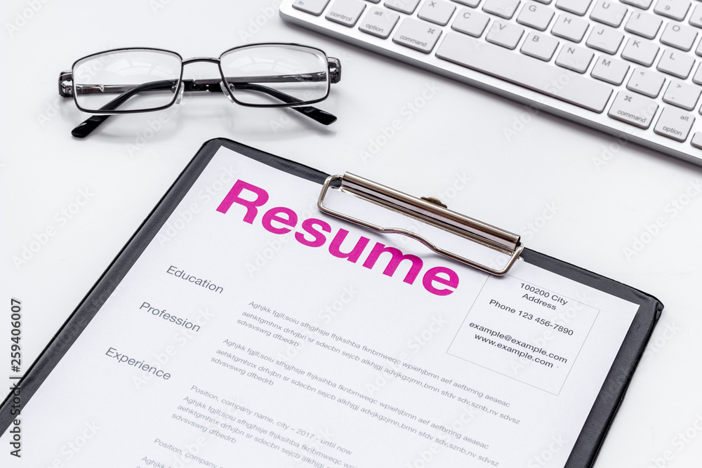 Create CV concept with glasses, keyboard on white desk top view Create CV concept with glasses, keyboard on white desk top view