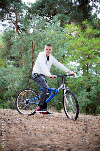 A man with a bicycle in the forest, active rest, healthy lifestyle