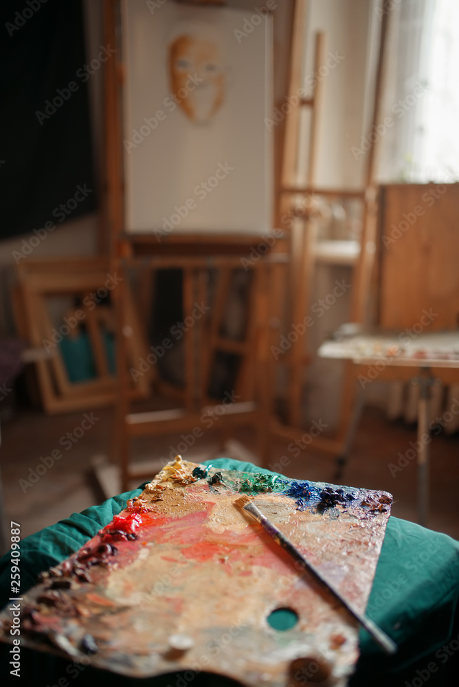 Color palette and brush, easel on background Color palette and brush, easel on background