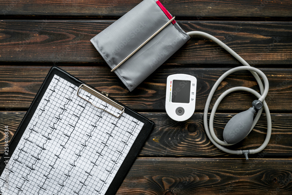 cardiologist work desk with pulsimeter and cardiogram on wooden background top view cardiologist work desk with pulsimeter and cardiogram on wooden background top view