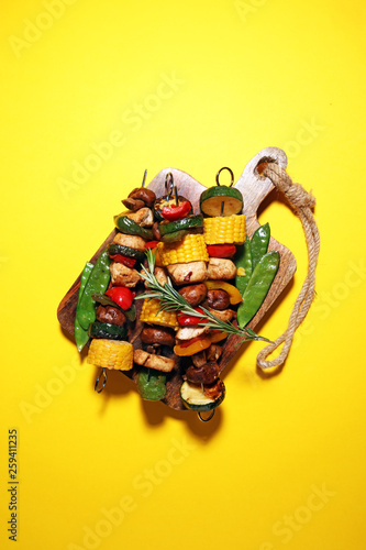 Assorted delicious grilled meat and skewer with vegetable on rustic table