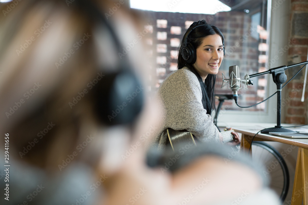 Portrait of smiling young woman sitting in studio Portrait of smiling young woman sitting in studio