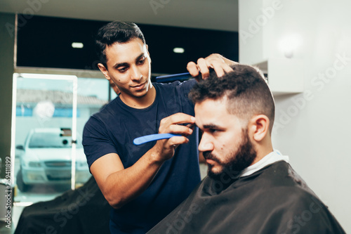 Client during beard and hair grooming in barber shop