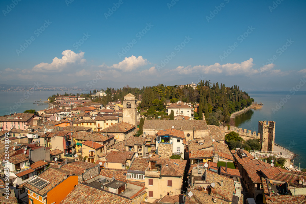High angle view of the historical center of the ancient town of Sirmione on the shore of Lake Garda in a sunny spring day, Lombardy, Italy