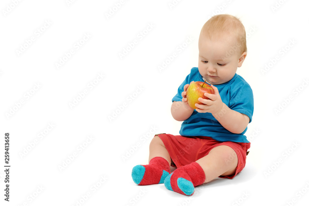 Baby boy with an apple on white background Baby boy with an apple on white background