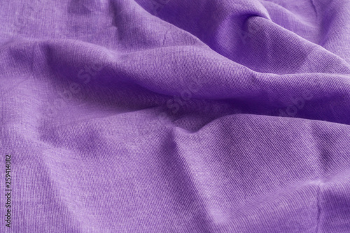 Purple fabric texture. Waves and crumpled. Selective focus