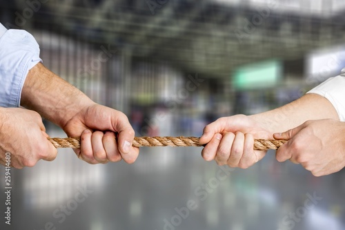 Business men hands holding rope on background