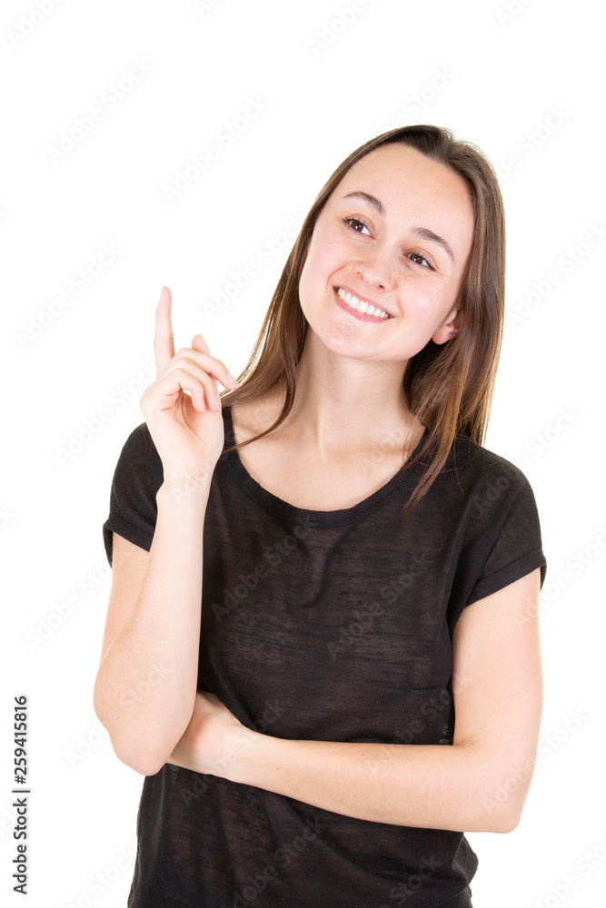 happy young woman pointing upwards looking in camera happy young woman pointing upwards looking in camera