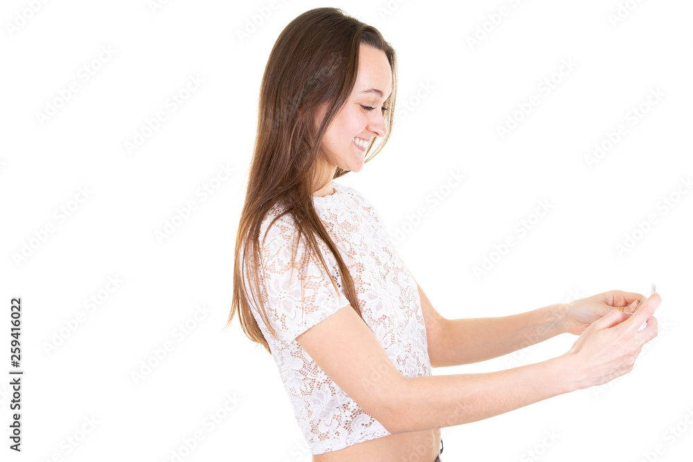 young woman with mobile phone looking down in isolated white background young woman with mobile phone looking down in isolated white background